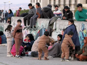 Displaced families gather in the streets to reach safety