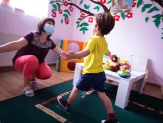 Childcare worker and child at a centre in Albania.