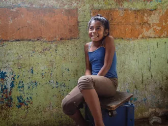 Duglianis sits inside her home in Petare, Venezuela.