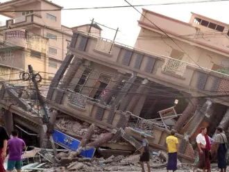 A building in Myanmar showing visible signs of destruction, with collapsed walls and debris, caused by a powerful earthquake.