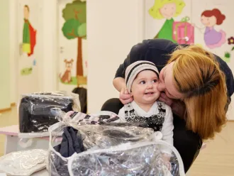 Mother putting on a warm cap on child's head