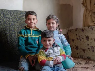 Haifa's children pose inside their temporary home