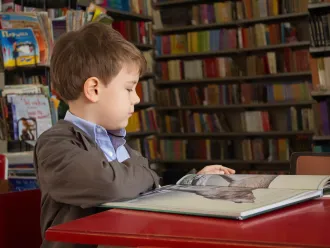 Boy reading in a library