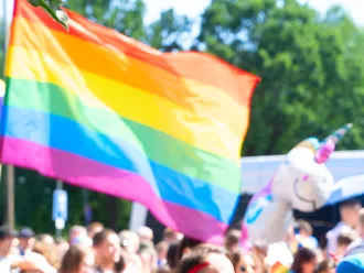 A picture of pride flag at a pride march. 